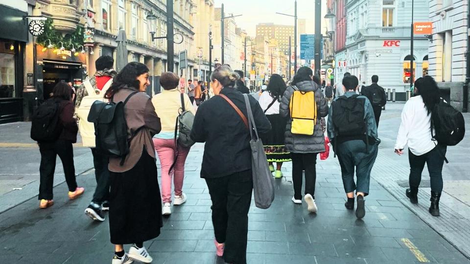 Group of visitors walking down street