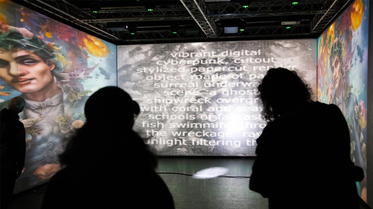 Two figures in silhouette against an immersive digital artwork