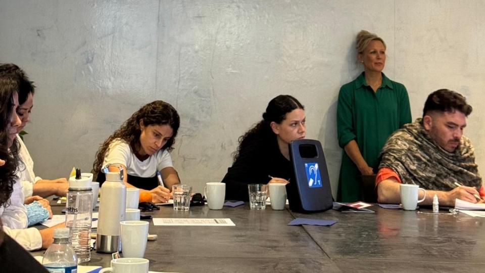 Participants taking part in desktop activity overlooked by female academic standing