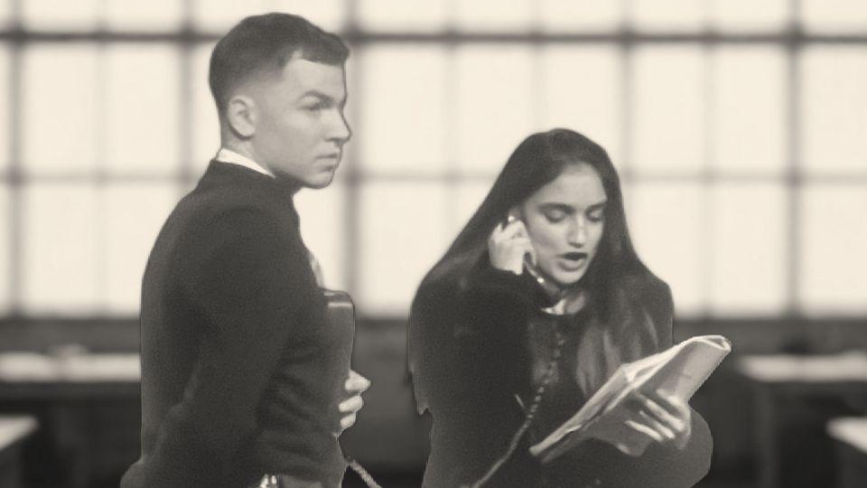 Prison guard (male) watches young woman who is in phone