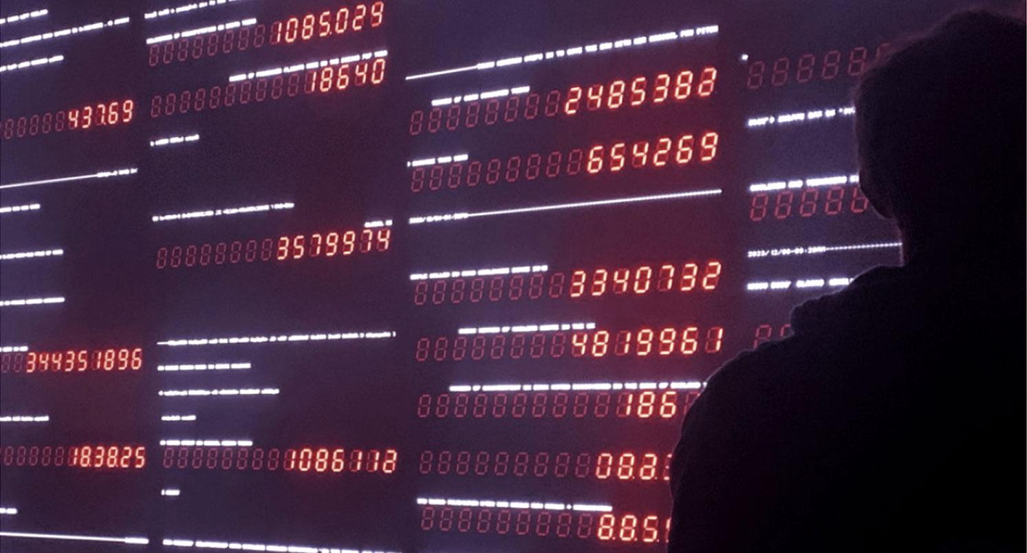 The shadow of the back of a student's head while they're looking at a numbers-based art work