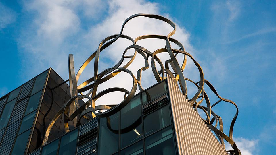 The squiggle on the top of the Ben Pimlott Building against the blue sky