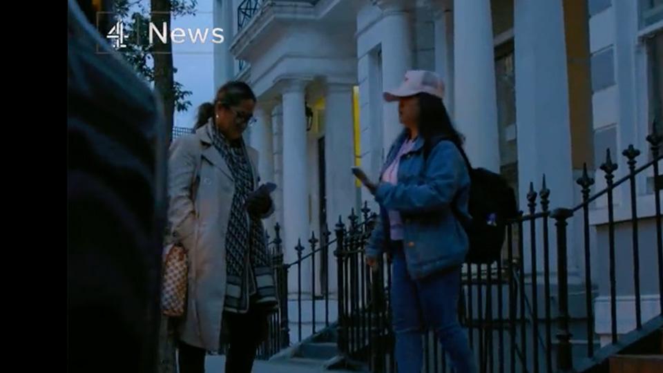 Two campaigners from self-help group Voice of Domestic Workers outside a white stuccoed mansion in west London