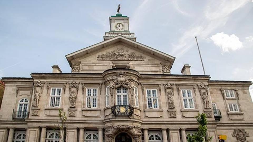 Front of Victorian, imposing Town Hall building with ornate carved facade