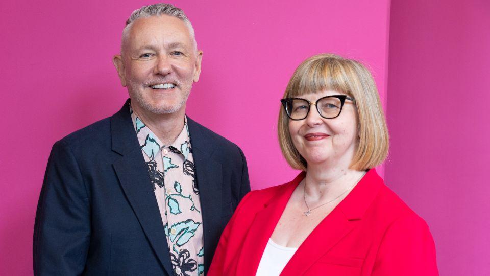 Gavin Barlow wearing a dark jacket and Annabel Turpin wearing a red blazer