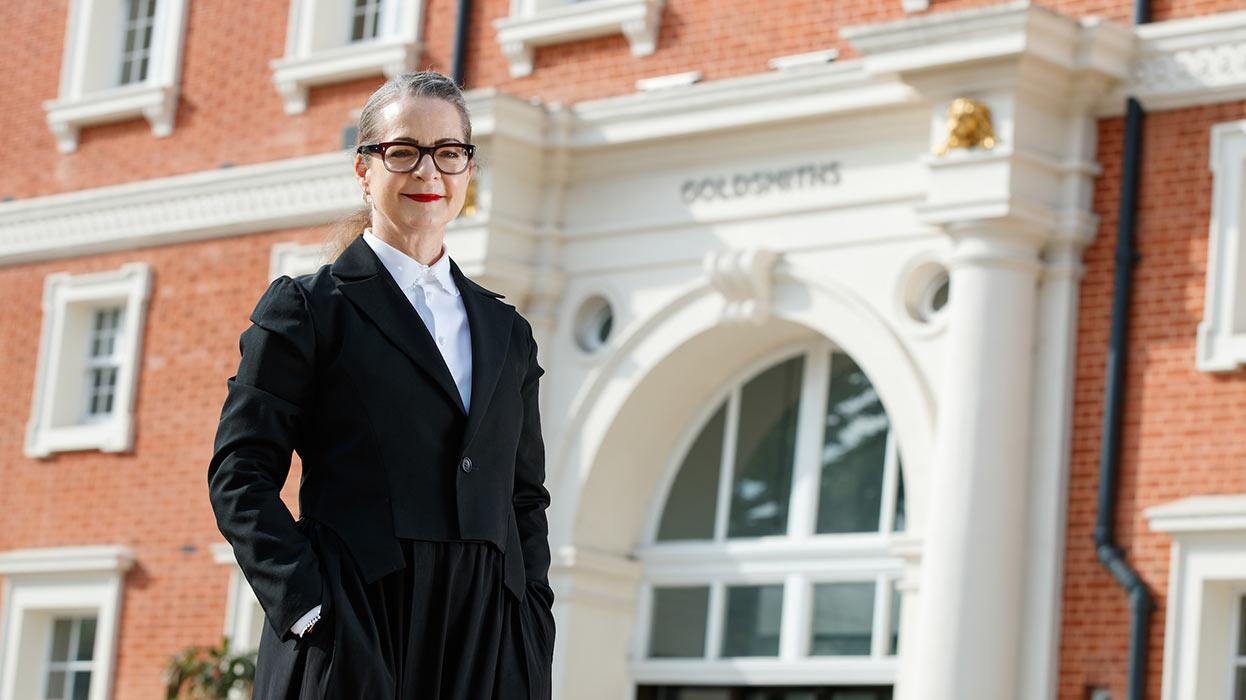Professor Frances Corner outside the main entrance of Richard Hoggart Building on our campus