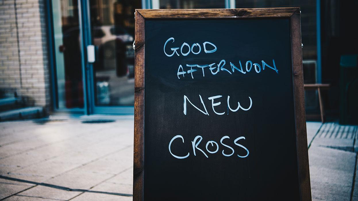 A chalkboard reading welcome to New Cross