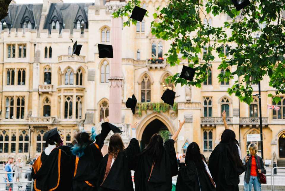 Students throwing mortar boards at graduation. 