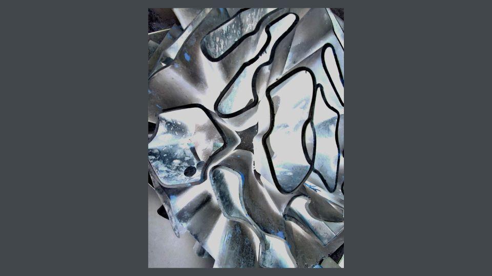 Close-up of installation created using grey, recycled metal from vaping batteries