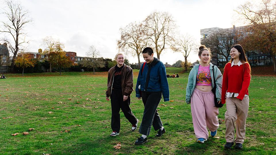 Students walking on the campus green.