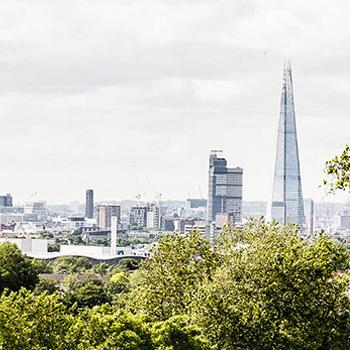 London skyline with clear skies and green trees