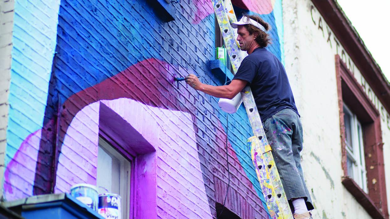 A main painting a wall mural