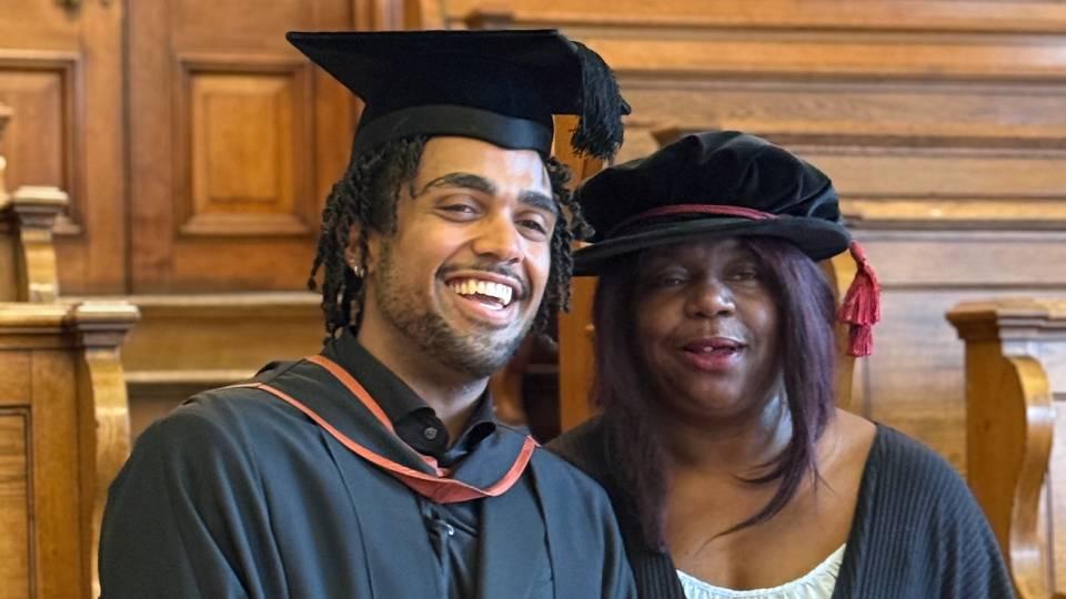 Male grad (left) poses with female academic (right)