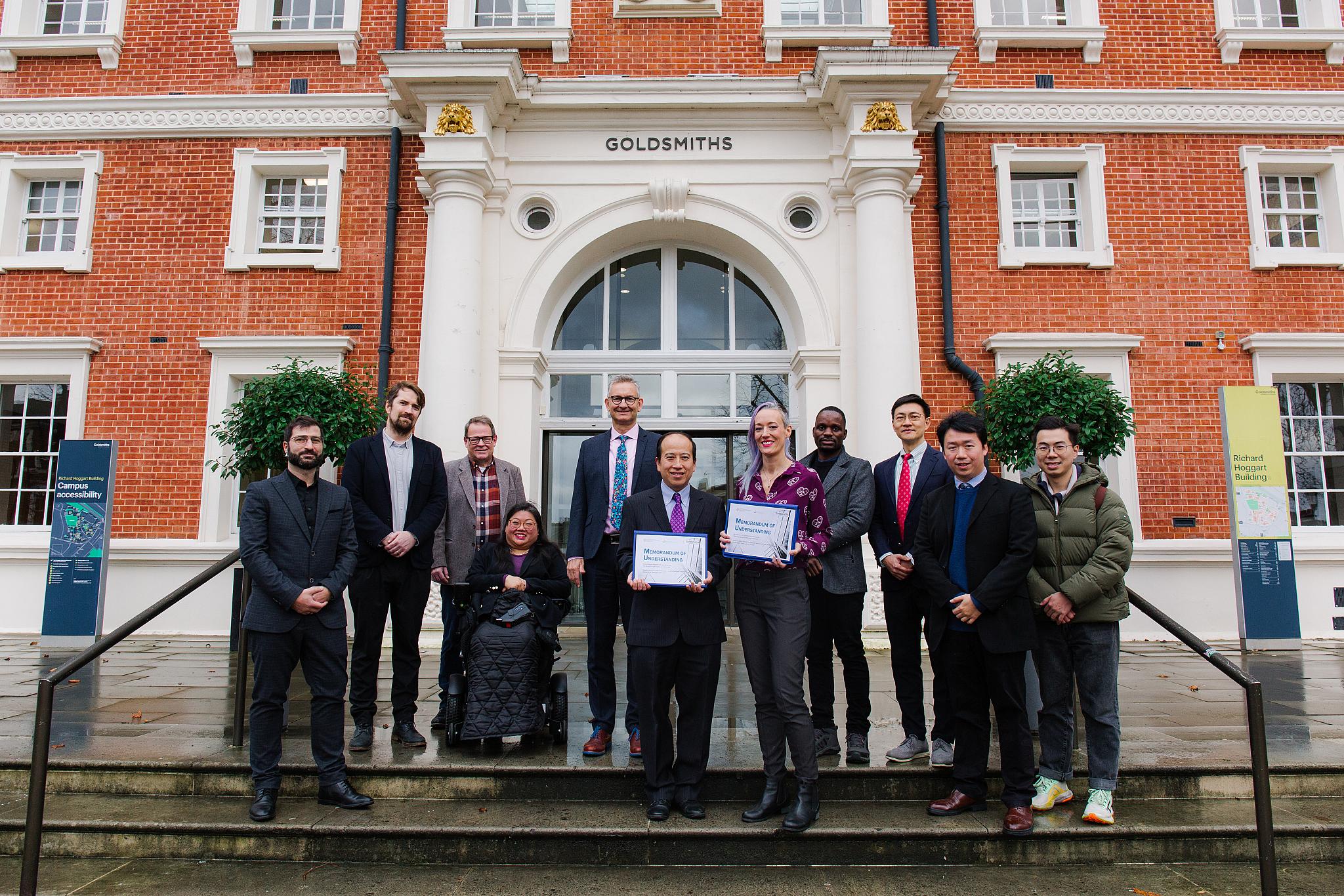 Staff from Goldsmiths and Hong Kong PolyU gather outside Goldsmiths. 