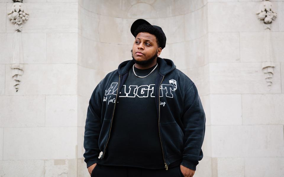 A portrait of student Omar standing on the Goldsmiths campus