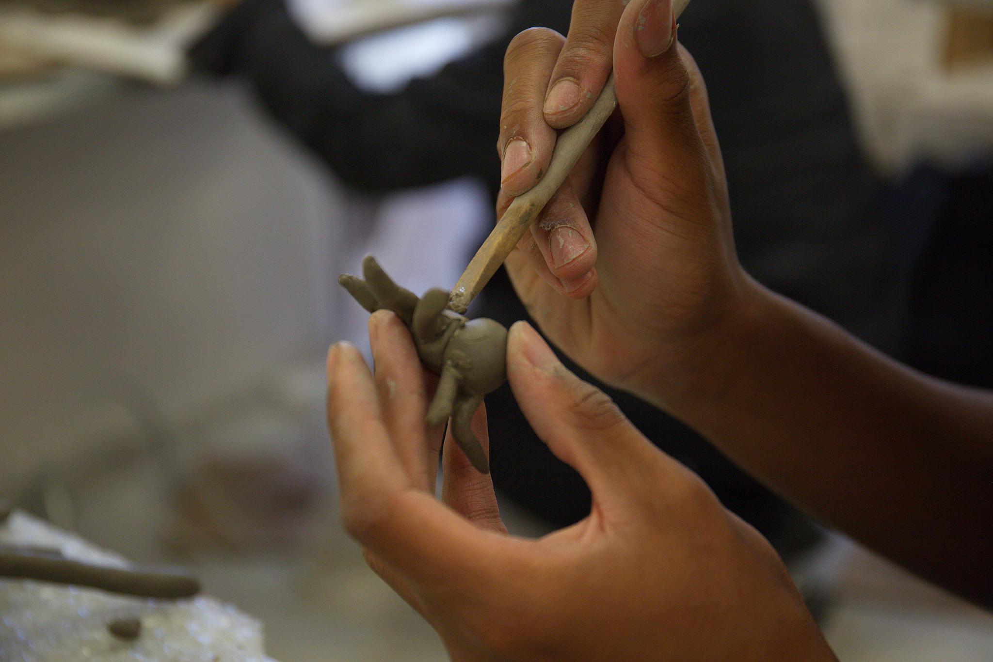 close-up of hands, precision clay work 