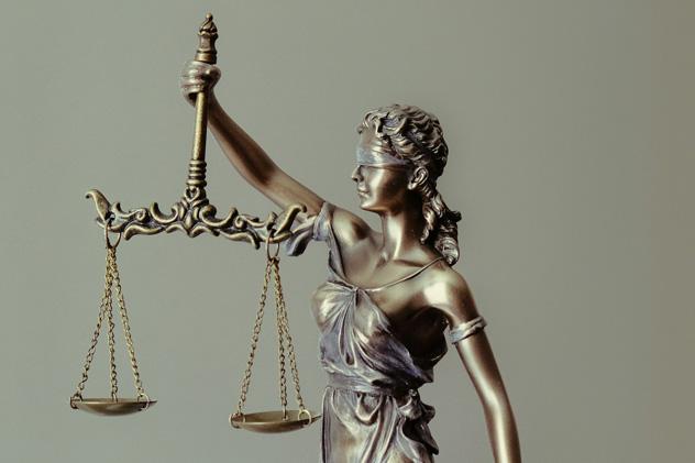 A bronze statue of Lady Justice, a representation of the moral force in justice systems