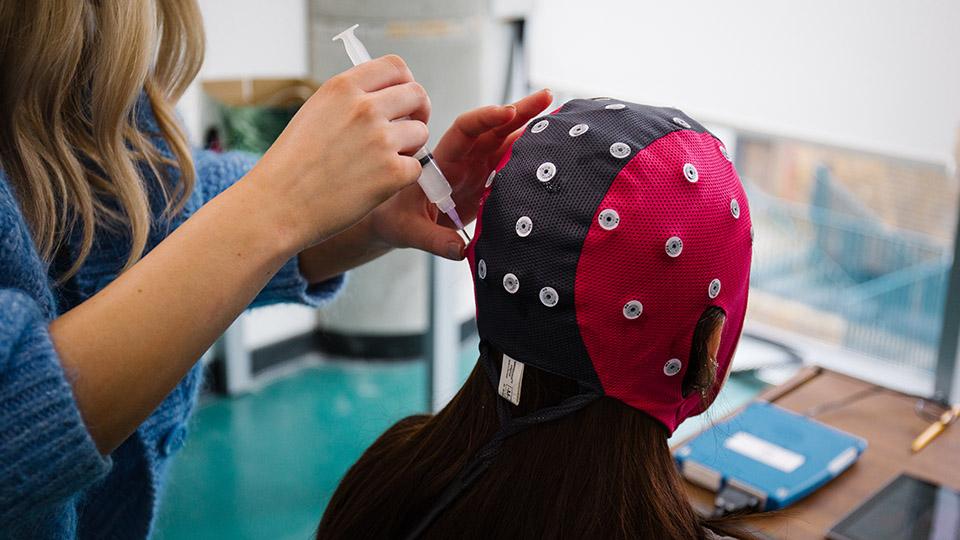 A student wearing a EEG hat.