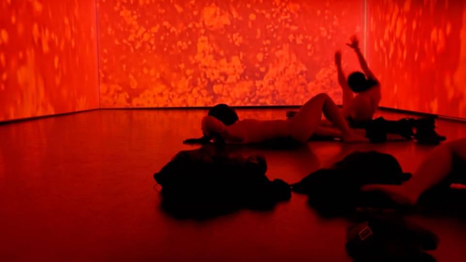 Red cloudlike visuals projected onto walls