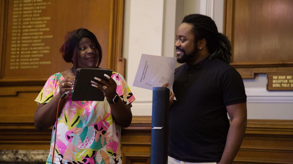 Female (left) introduces male (right) on stage 