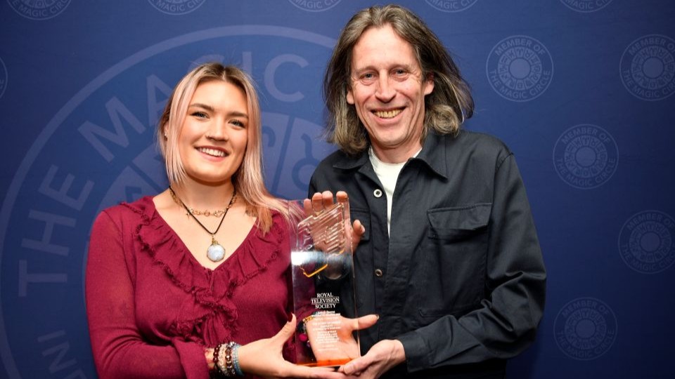 Graduate Sophie Sutcliffe and lecturer Ben Unwin holding the glass RTS London Student Awards trophy 