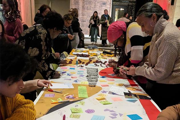 People take part in a writing workshop at a museum late