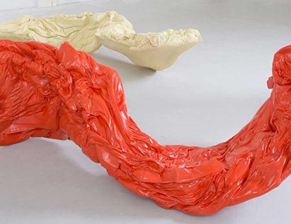 An orange textile form in the foreground