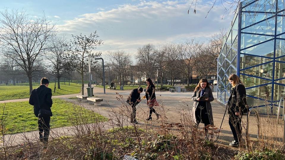 Pupils are seen looking around their local park