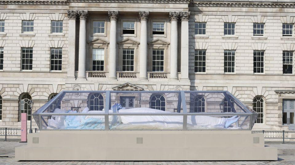 The giant blue figure in a glass casket in the courtyard.