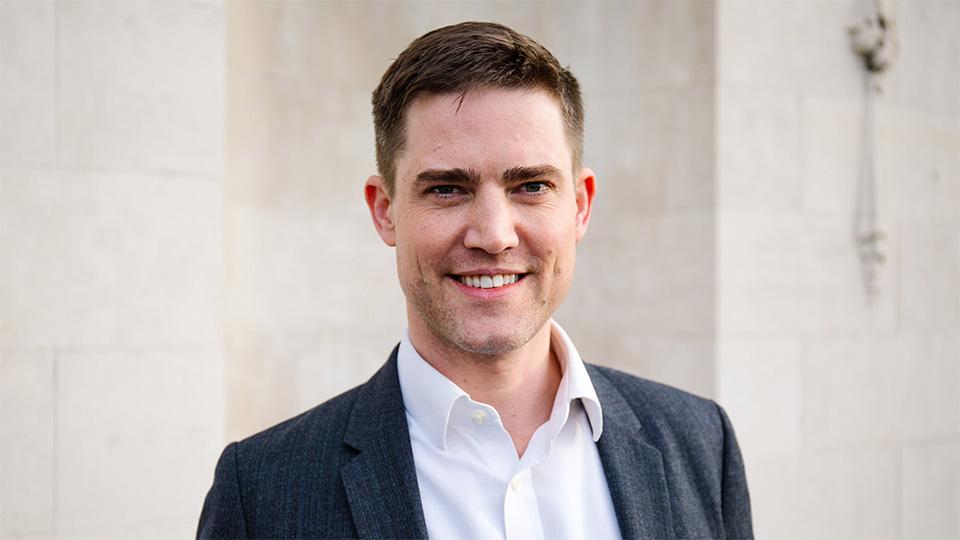 Portrait of Tom Sleigh in front of the Richard Hoggart Building 