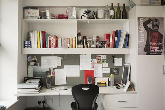 A student desk in halls with shelves