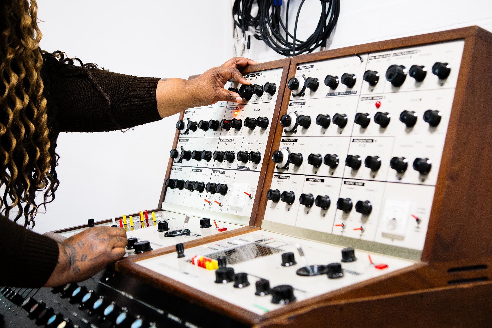 The VCS4 synthesiser, made of two analogue synthesisers. There are oscillators and it is enclosed in a wooden case.