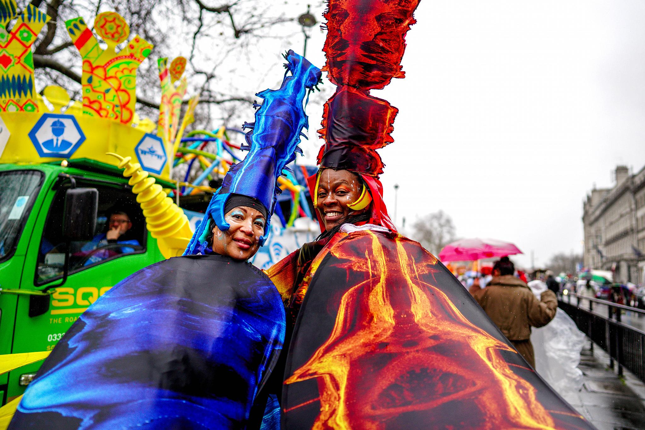 Two performers wearing costumes printed with sonar imagery. 