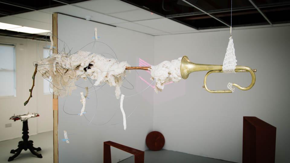 Artwork comprised of suspended installation installation of rabbit skins, copper wire, and wood.