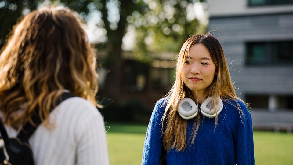 Students looking at each other on the College Green.