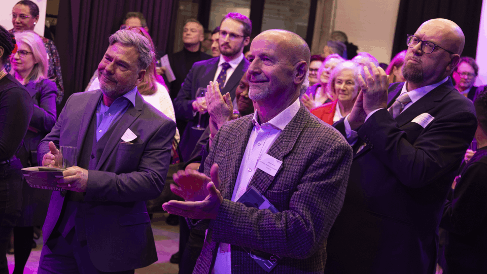 Guests applauding a student performance