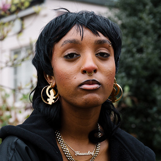A portrait of Heavadny, a young Black woman, in the Goldsmiths library